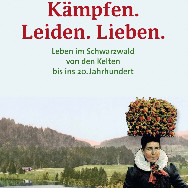 Plakat: Frau in traditioneller Schwarzwälder Tracht mit großem Blumenkopfschmuck vor einer Wald- und Wiesenlandschaft; darüber rote Schrift Kämpfen. Leiden. Lieben.